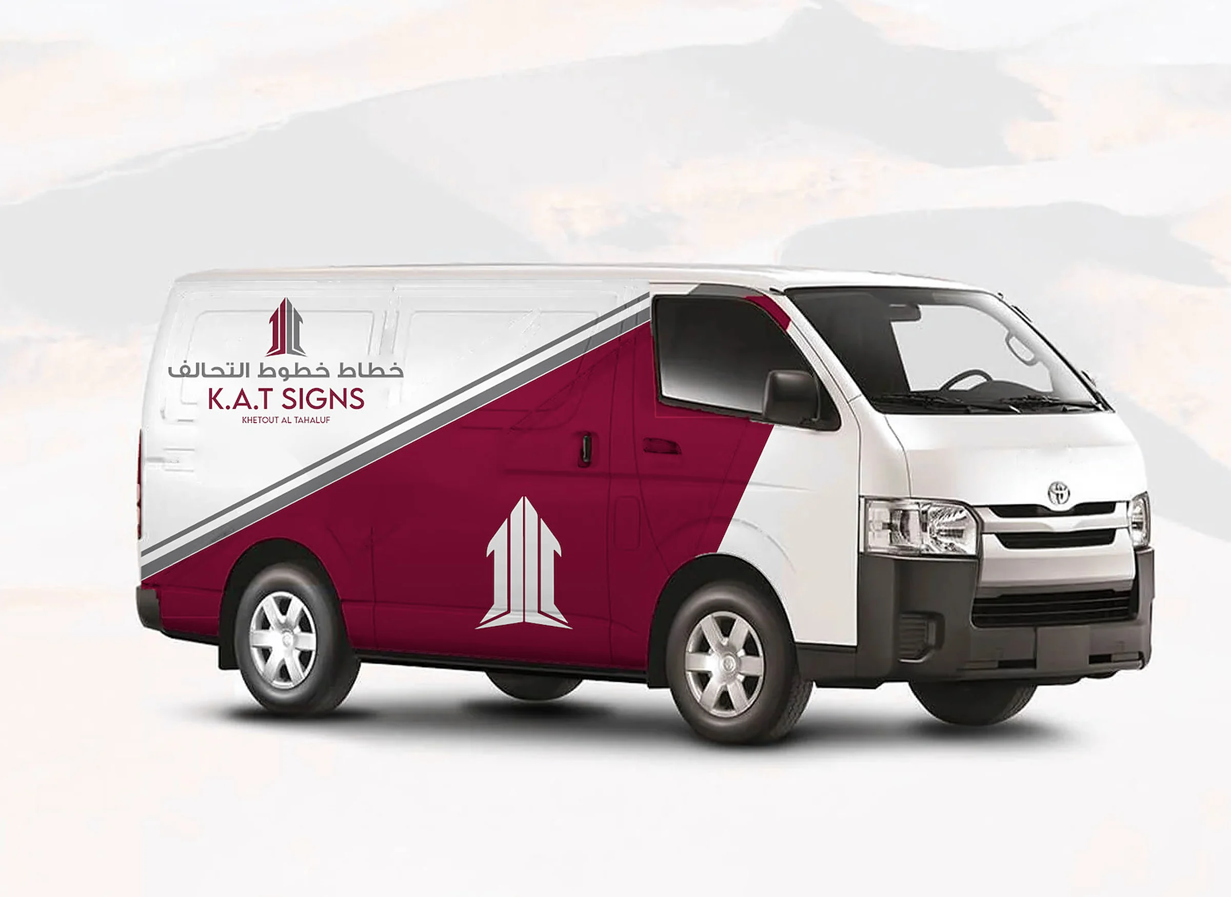 Van with a maroon and grey KAT Signs wrap